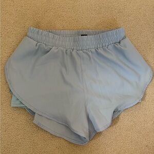 Light blue activewear shorts with built-in liner and elastic waistband